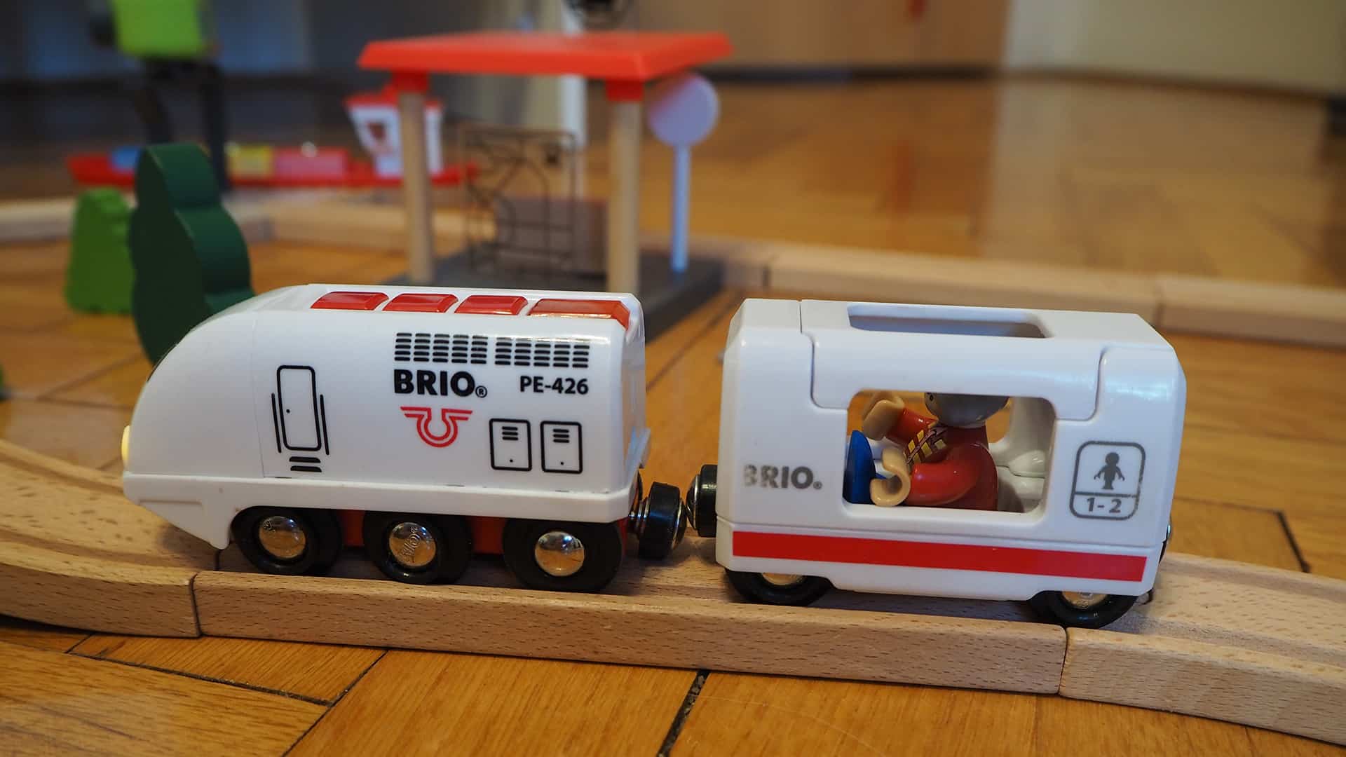 Eine Holzeisenbahn Batterielok mit Waggon und Figur